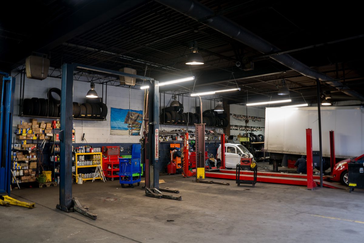 The service bays with lifts, tool carts and shelves of parts